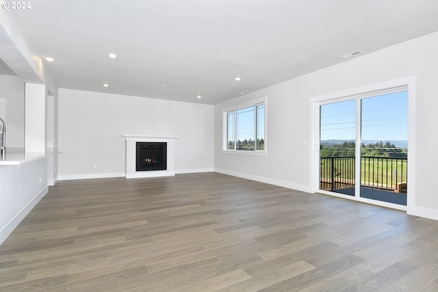 unfurnished living room with hardwood / wood-style floors