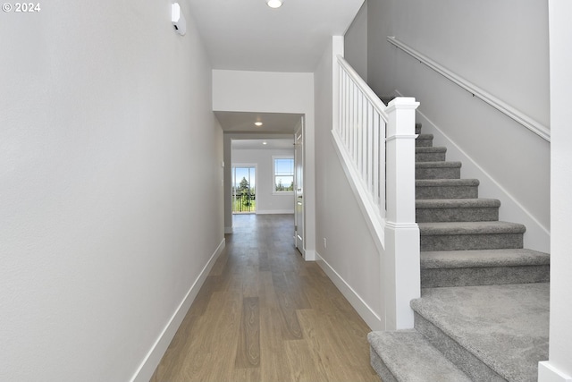 corridor with hardwood / wood-style flooring