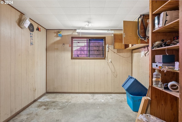 below grade area with baseboards and wood walls