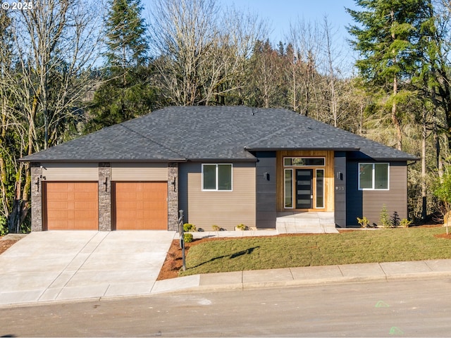 prairie-style house with a garage and a front lawn