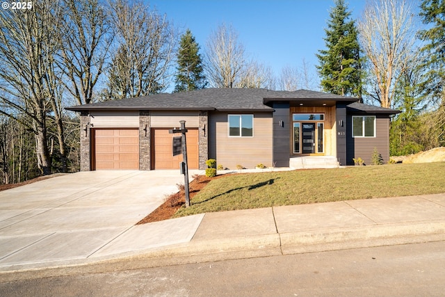 prairie-style house featuring a garage and a front yard