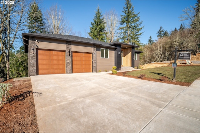 view of front of home with a garage and a front lawn