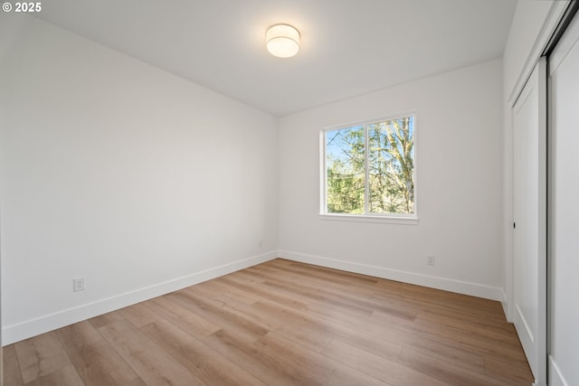 unfurnished bedroom featuring light hardwood / wood-style floors and a closet