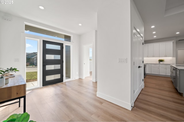 entrance foyer with sink and light hardwood / wood-style floors