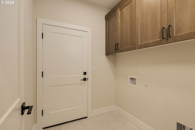 laundry room featuring washer hookup and cabinets