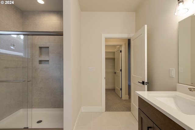 bathroom with vanity, tile patterned flooring, and a shower with shower door