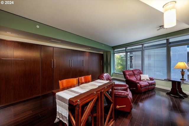 dining area with visible vents, baseboards, and hardwood / wood-style flooring