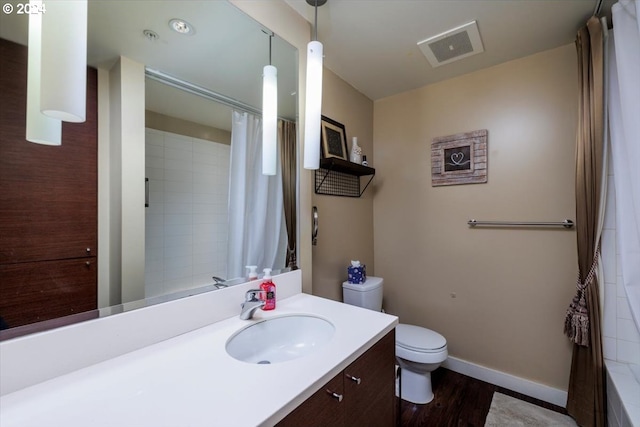 bathroom featuring a shower with curtain, vanity, hardwood / wood-style floors, and toilet