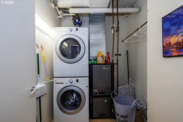 washroom featuring stacked washer and clothes dryer