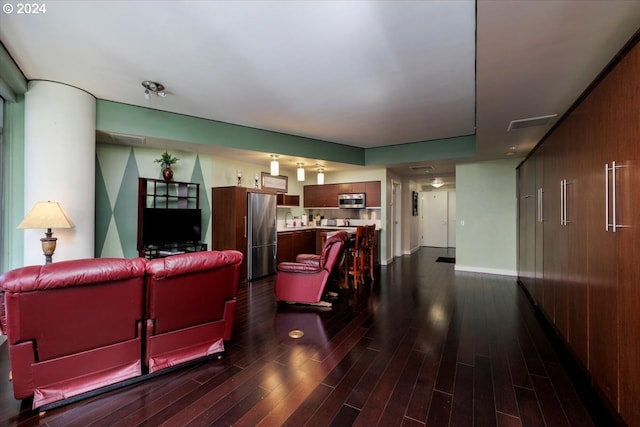 living room with dark hardwood / wood-style flooring and sink