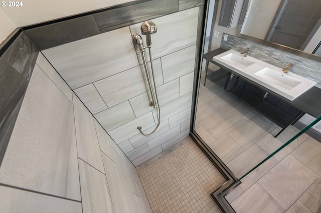 bathroom with walk in shower, tasteful backsplash, vanity, and tile patterned flooring