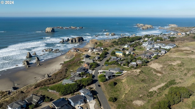 bird's eye view featuring a water view and a beach view