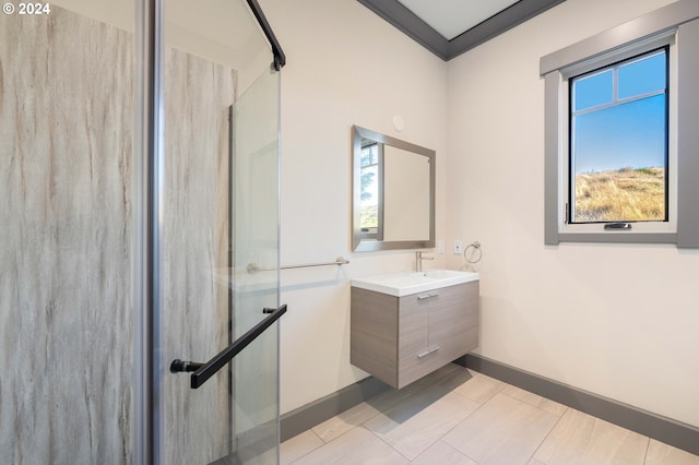 bathroom with vanity, a wealth of natural light, a shower with door, and crown molding