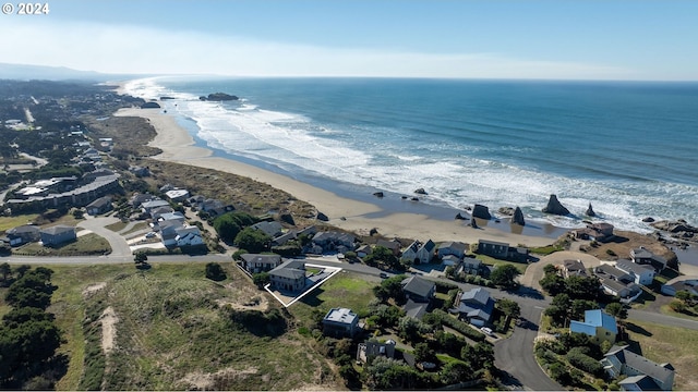 drone / aerial view with a beach view and a water view