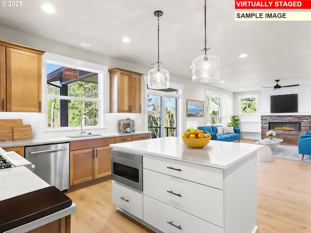 2854 NE Sweetwater Rd, Estacada, OR 97023 - kitchen with open floor plan, stainless steel appliances, light wood-type flooring, and a sink