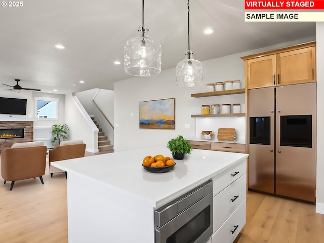 2854 NE Sweetwater Rd, Estacada, OR 97023 - kitchen with stainless steel appliances, light countertops, light wood-style floors, pendant lighting, and ceiling fan