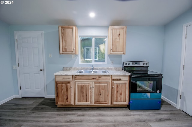 kitchen featuring range with electric cooktop, light brown cabinetry, light hardwood / wood-style floors, and sink