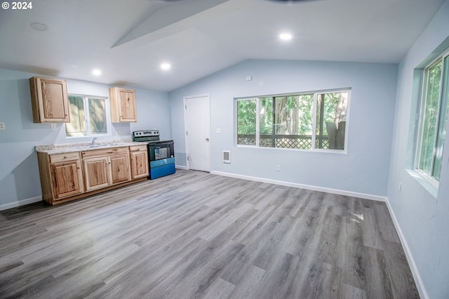 kitchen featuring stainless steel range with electric stovetop, lofted ceiling, sink, and light hardwood / wood-style flooring