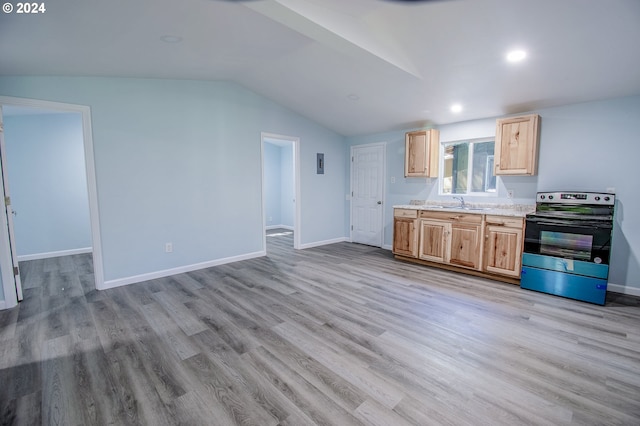 kitchen with lofted ceiling, sink, electric range, light stone countertops, and light hardwood / wood-style flooring