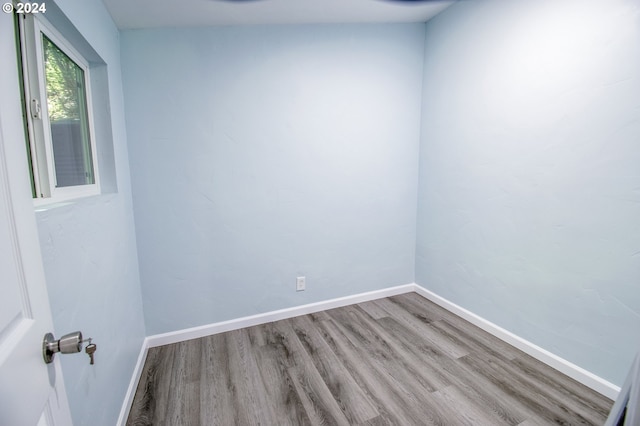 empty room with hardwood / wood-style floors