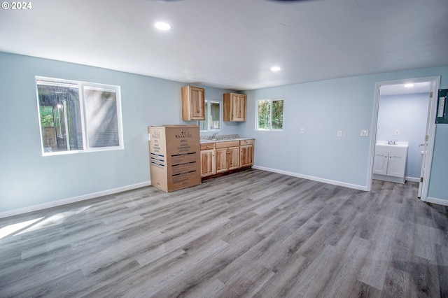 kitchen with sink and light hardwood / wood-style floors