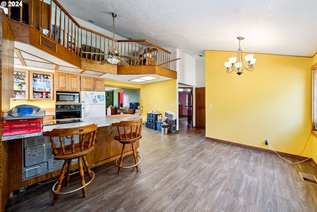 kitchen with ceiling fan with notable chandelier, light hardwood / wood-style floors, stainless steel microwave, white fridge, and black oven