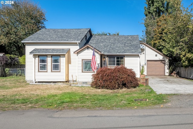 view of front of property featuring a garage and a front lawn