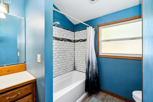 full bathroom featuring hardwood / wood-style floors, vanity, toilet, and shower / tub combo