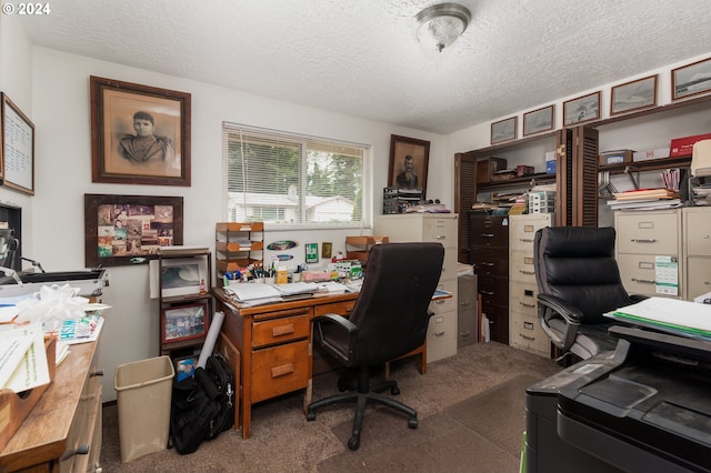 carpeted home office with a textured ceiling