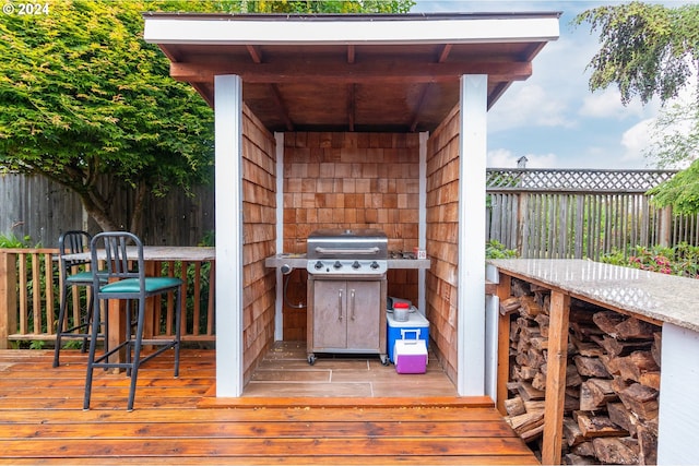 wooden deck with a grill