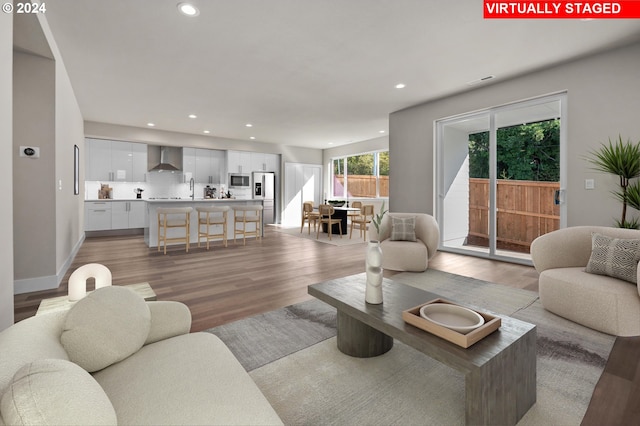 living room featuring sink and light hardwood / wood-style floors