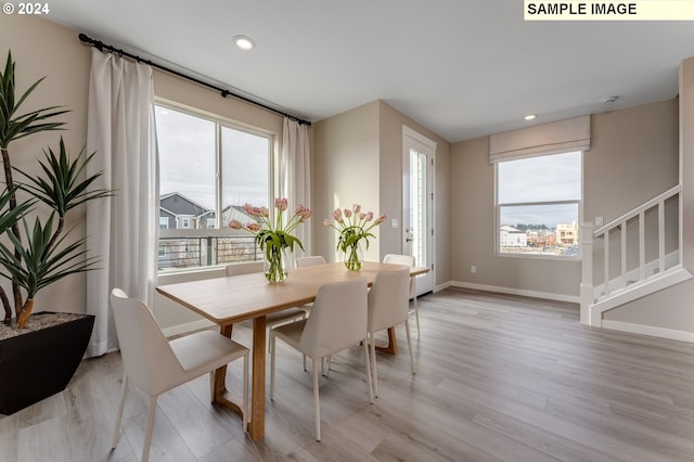 dining space with light hardwood / wood-style floors