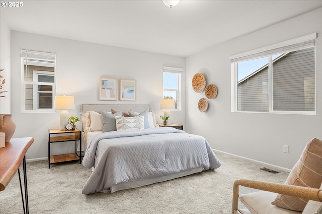 carpeted bedroom with multiple windows