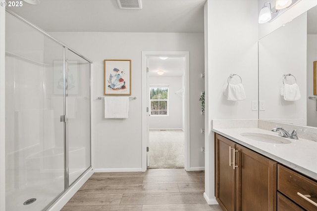 bathroom featuring vanity, hardwood / wood-style flooring, and an enclosed shower