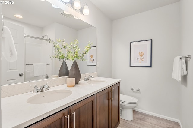 bathroom with vanity, toilet, a shower, and wood-type flooring