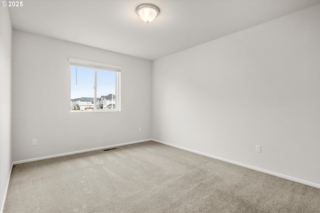 empty room with light colored carpet