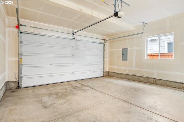 garage featuring electric panel and a garage door opener