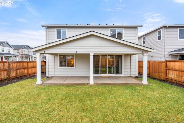 back of property featuring a patio and a lawn