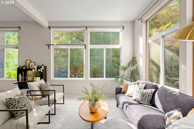 sunroom / solarium featuring beam ceiling and a wealth of natural light