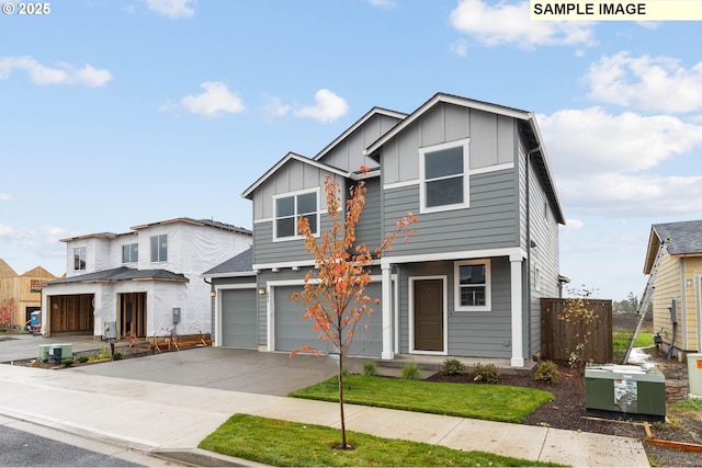 1353 NE Josephine Ct Unit 167, Estacada, OR 97023 - view of front of house featuring driveway, an attached garage, board and batten siding, and fence