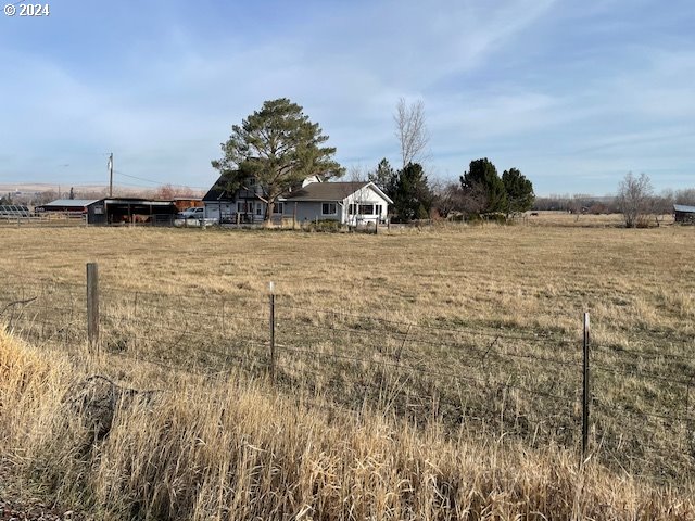 view of yard with a rural view