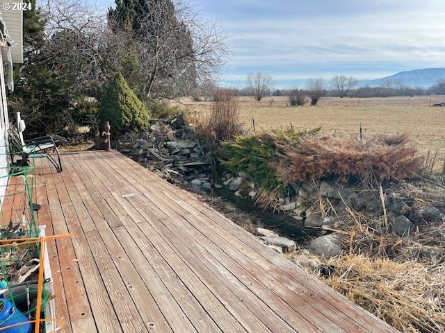 wooden deck with a mountain view