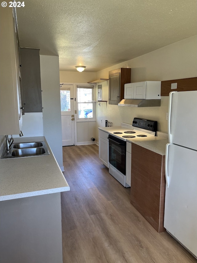 kitchen with a textured ceiling, white appliances, sink, light hardwood / wood-style flooring, and white cabinets