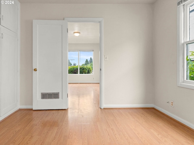 unfurnished room with light wood-type flooring