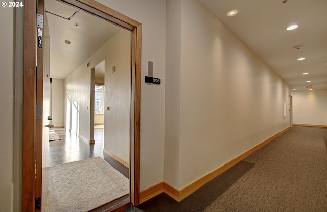 hallway featuring dark carpet