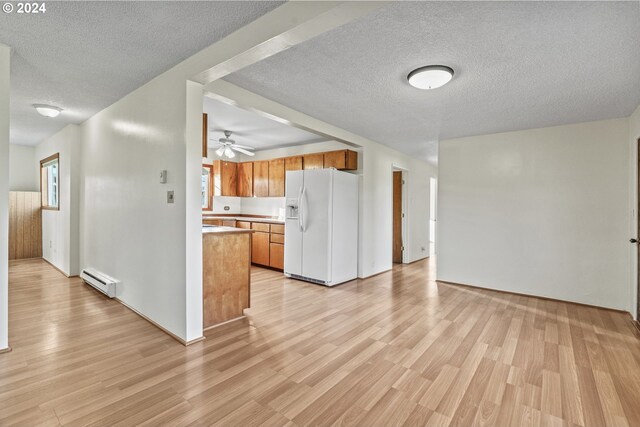 252 State Route 409, Cathlamet, WA 98612 - kitchen featuring white fridge with ice dispenser, a textured ceiling, ceiling fan, and light wood-type flooring