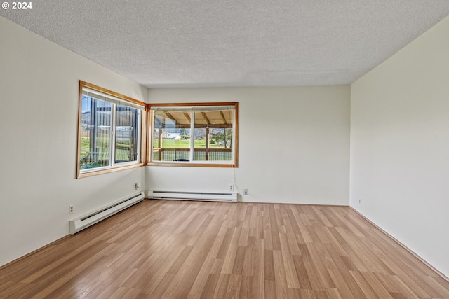 252 State Route 409, Cathlamet, WA 98612 - spare room with baseboard heating, a textured ceiling, and light wood-type flooring