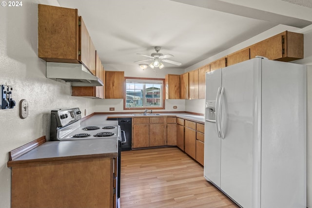 252 State Route 409, Cathlamet, WA 98612 - kitchen featuring ceiling fan, white fridge with ice dispenser, light hardwood / wood-style flooring, range with electric stovetop, and wall chimney range hood