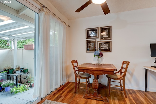 dining space featuring hardwood / wood-style flooring and ceiling fan