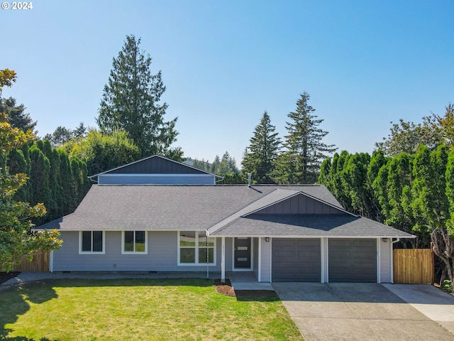 single story home featuring a garage and a front yard